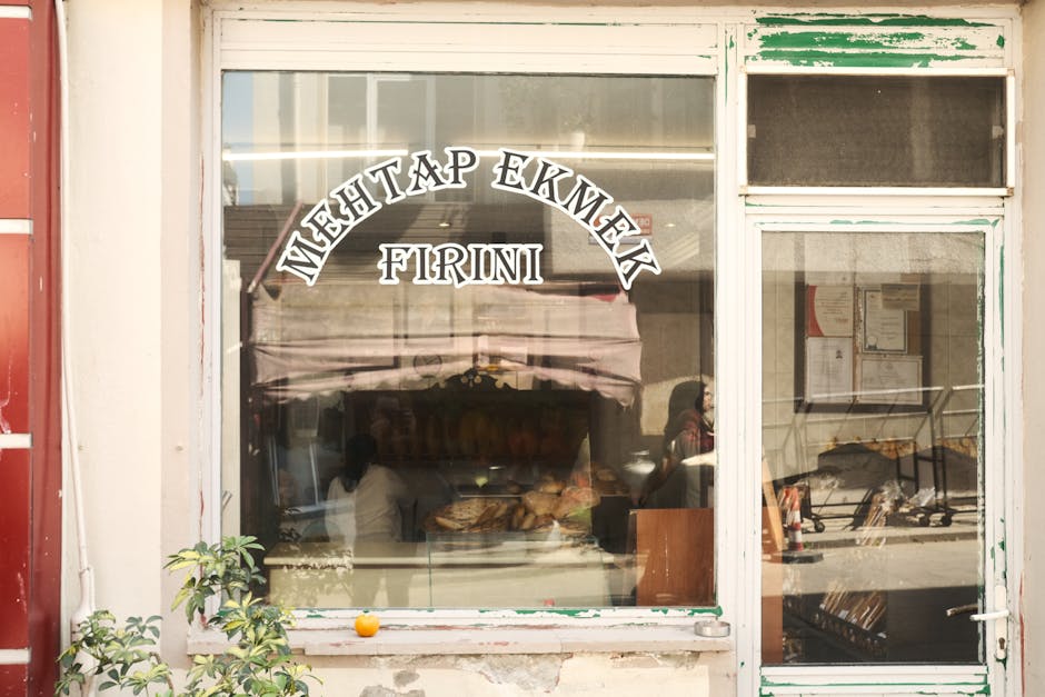 A charming view of a traditional bakery storefront with fresh bread in the window.